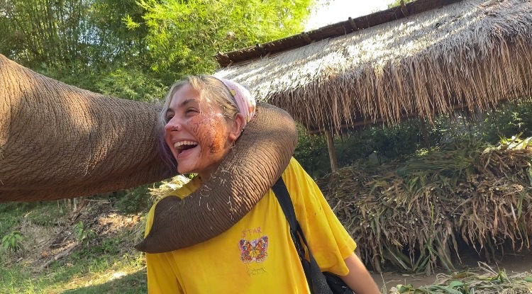 Star Neorr being hugged by an elephant