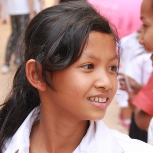 A young girl smiling.