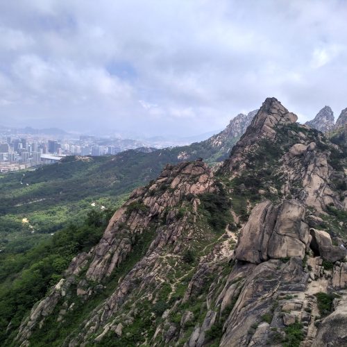 A mountain range with a large city in the background.
