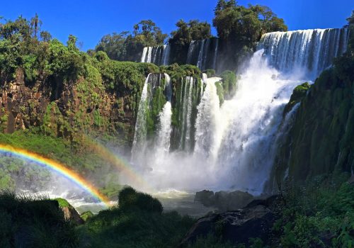 A series of waterfalls making rainbows.