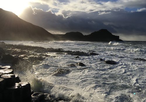 A beach with mountains in the background in Northern Ireland