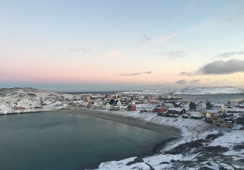 A small Norwegian town in a harbor.