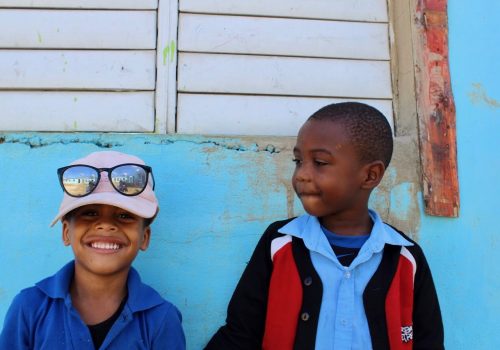 Two young boys smiling together.