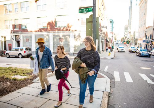 three people walking in downtown asheville